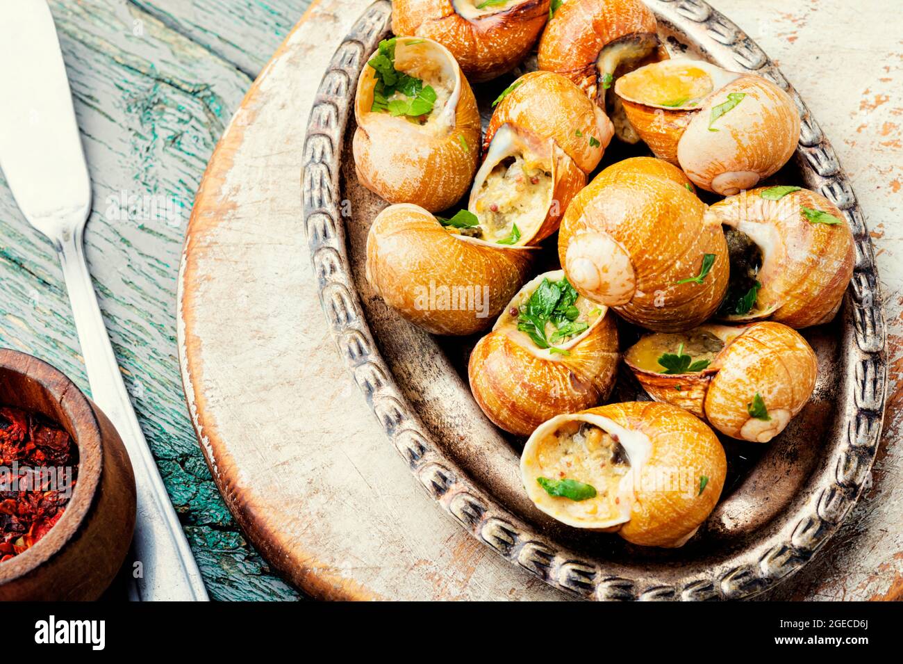 Edible snails stuffed with green butter, French delicacies Stock Photo