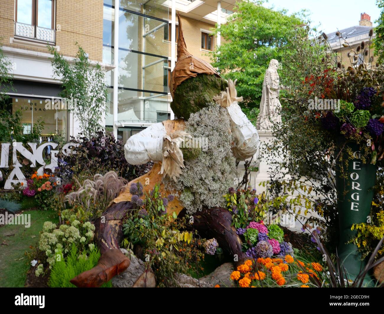 In celebration of the 50 th anniversary of George Harrison's masterpiece , All Things Must Pass ,floral global artist Ruth Davis designed a beautiful , interactive installation featuring a gigantic version of two gnomes created out of flowers and foliage .Two additional smaller gnomes can be viewed outside Abbey Road Studios , where the album was recorded in 1970 . These were created to pay tribute to George's love of nature . The installation will be available to visit until August 20 th . Stock Photo
