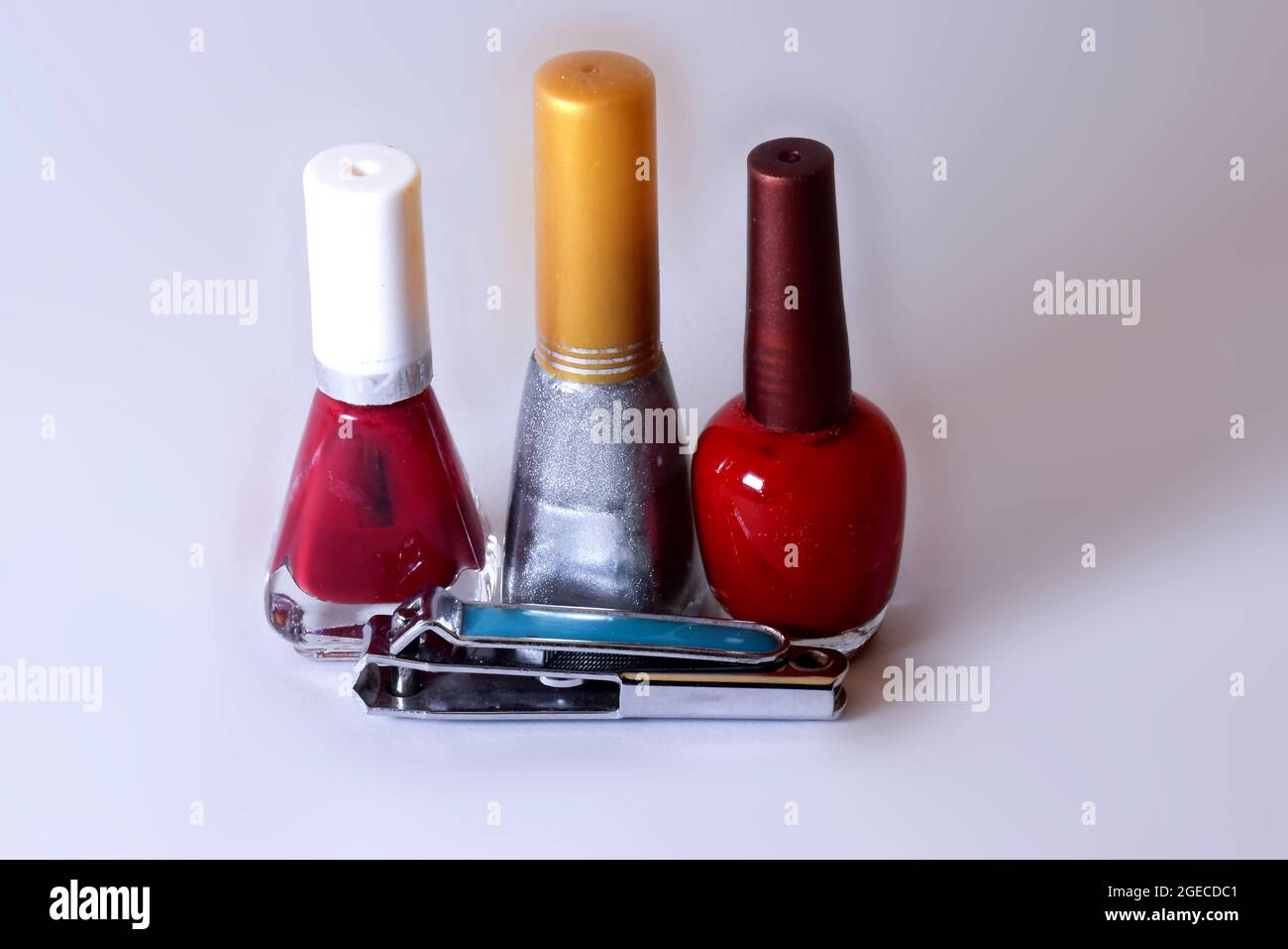 colorful nail polish and nail cutter with white background Stock Photo