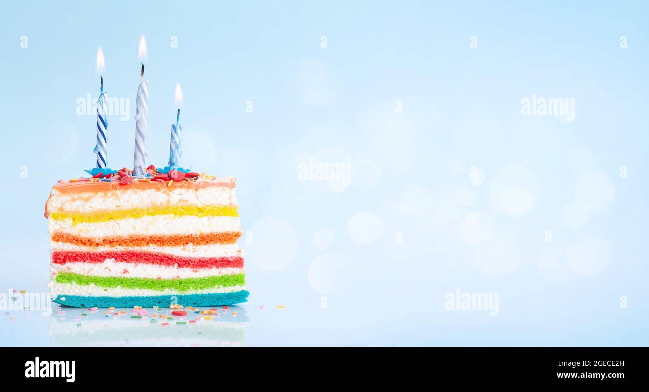 Birthday cake with burning candles on a blue background with copy space ...