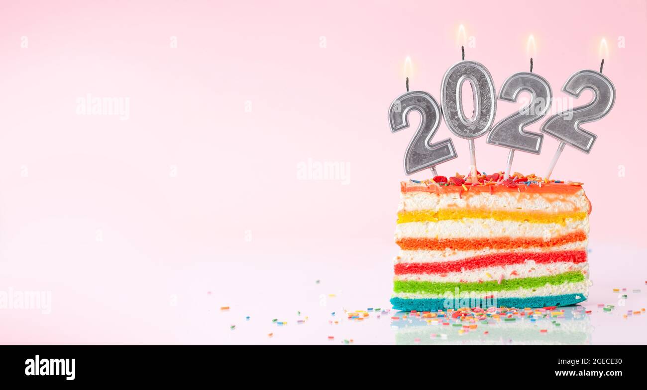 Christmas Cake With Number 2022 Burning Candles On A Pink Background With Copy Space For Your Xmas Greetings Stock Photo - Alamy