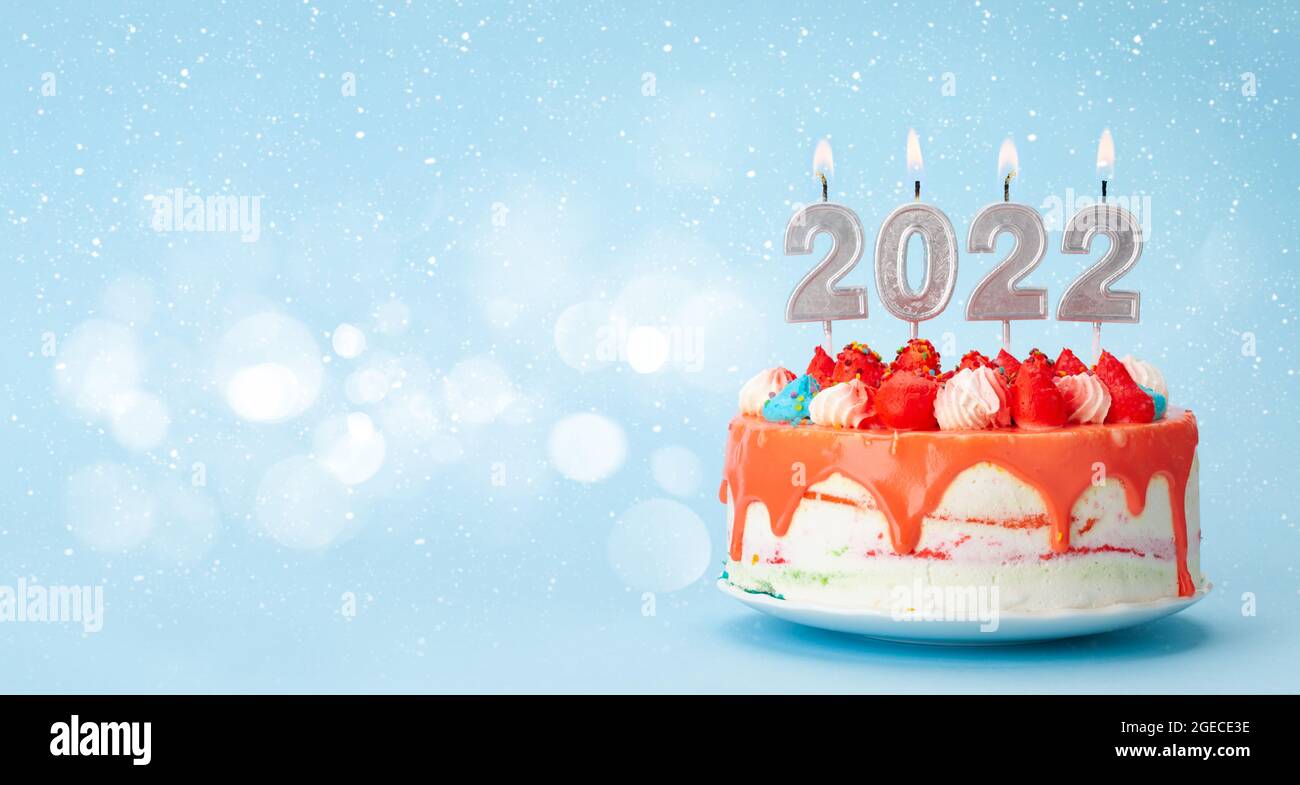 Christmas Cake With Number 2022 Burning Candles On A Blue Background With Copy Space For Your Xmas Greetings Stock Photo - Alamy