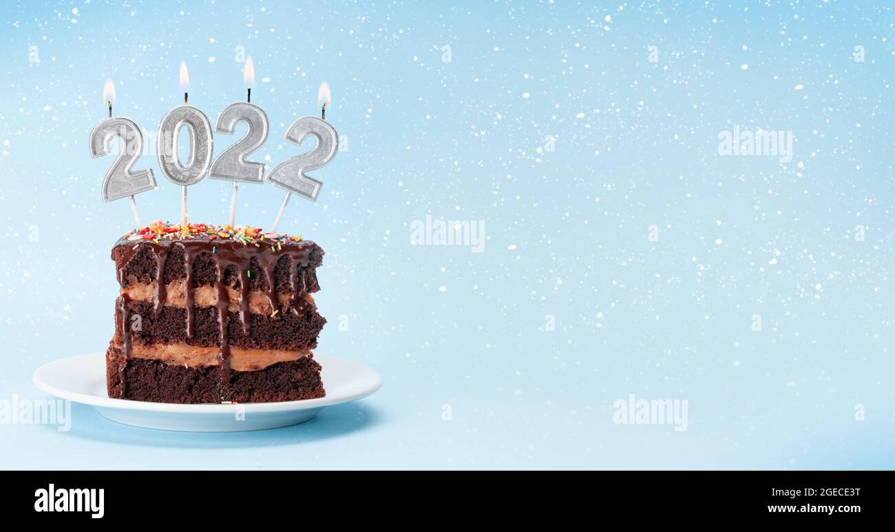 Christmas Cake With Number 2022 Burning Candles On A Blue Background With Copy Space For Your Xmas Greetings Stock Photo - Alamy