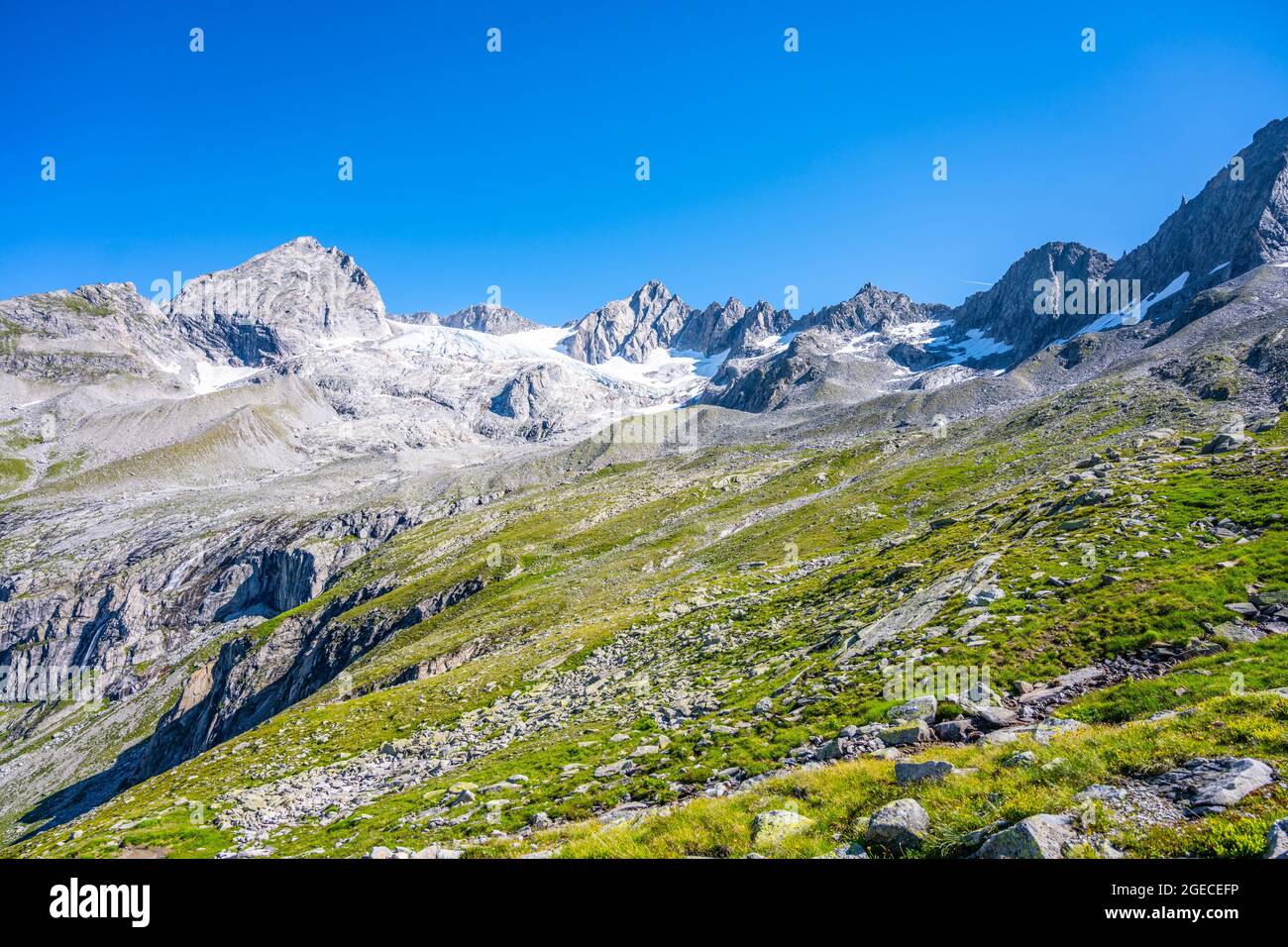 Summer alpine peaks with melting glacier on sunny day. Reichenspitze ridge in Zillertal Alps, Austria Stock Photo