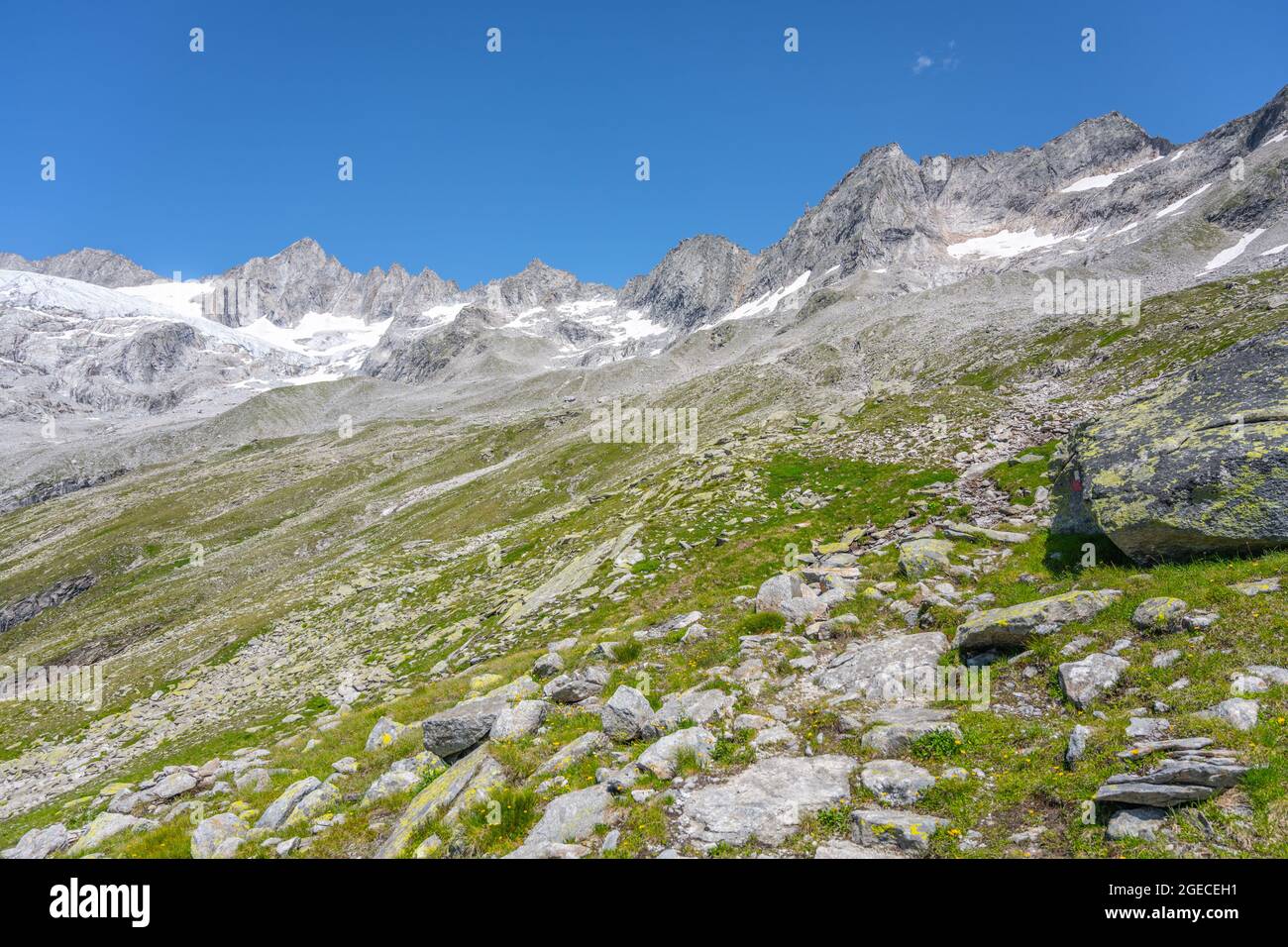 Summer alpine peaks with melting glacier on sunny day. Reichenspitze ridge in Zillertal Alps, Austria Stock Photo