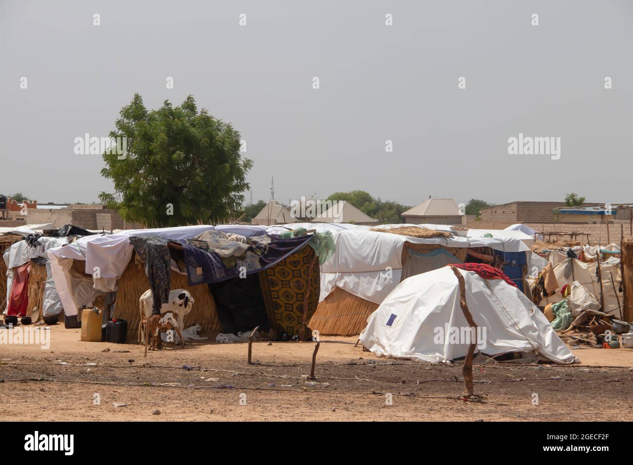 Refugee camp made of local materials and plastic sheeting, people living in very poor conditions, lack of clean water, lack of access to health Stock Photo