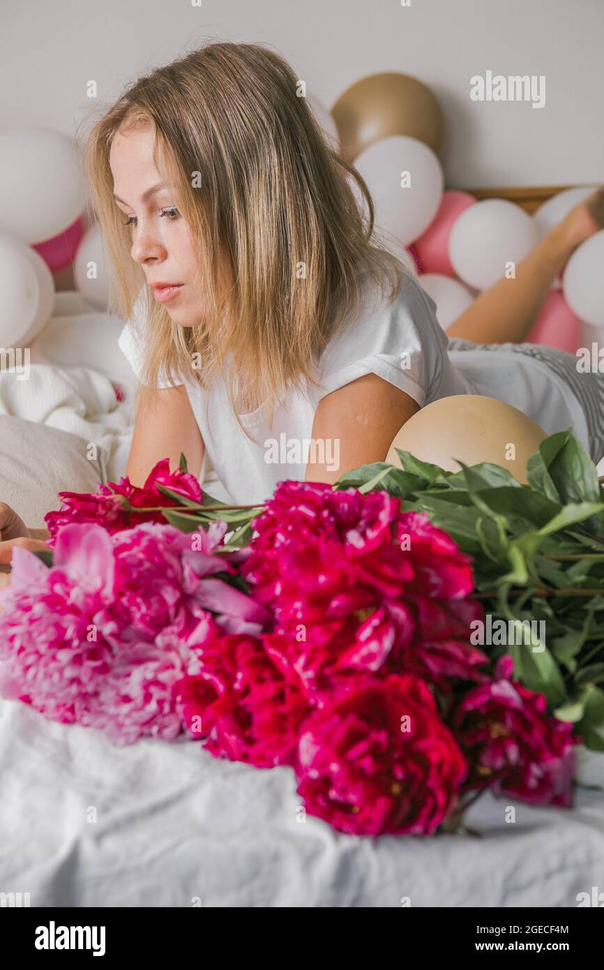 Image of a happy positive pretty young woman indoors at home in bedroom ...