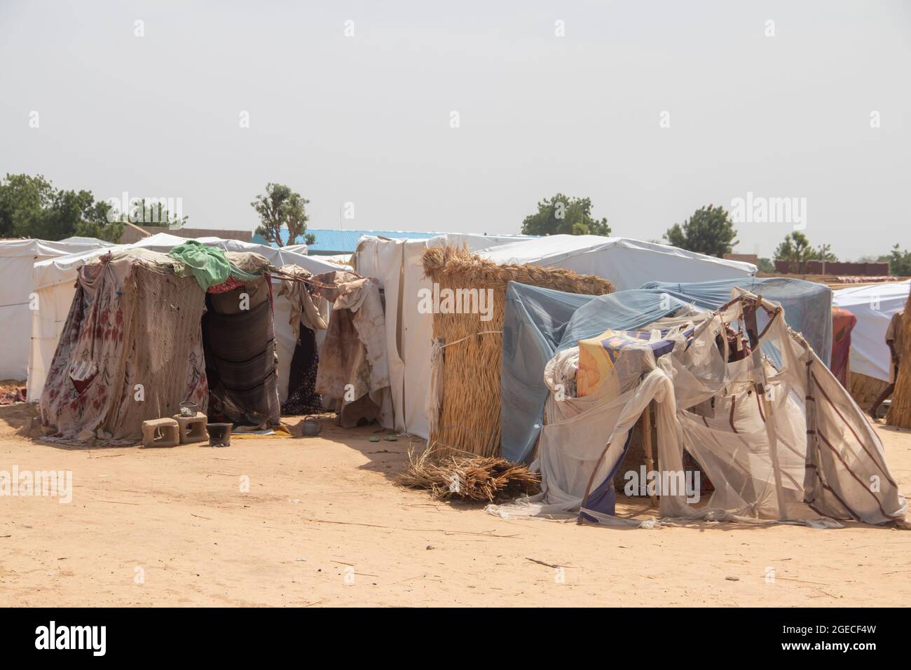 Refugee camp made of local materials and plastic sheeting, people living in very poor conditions, lack of clean water, lack of access to health Stock Photo