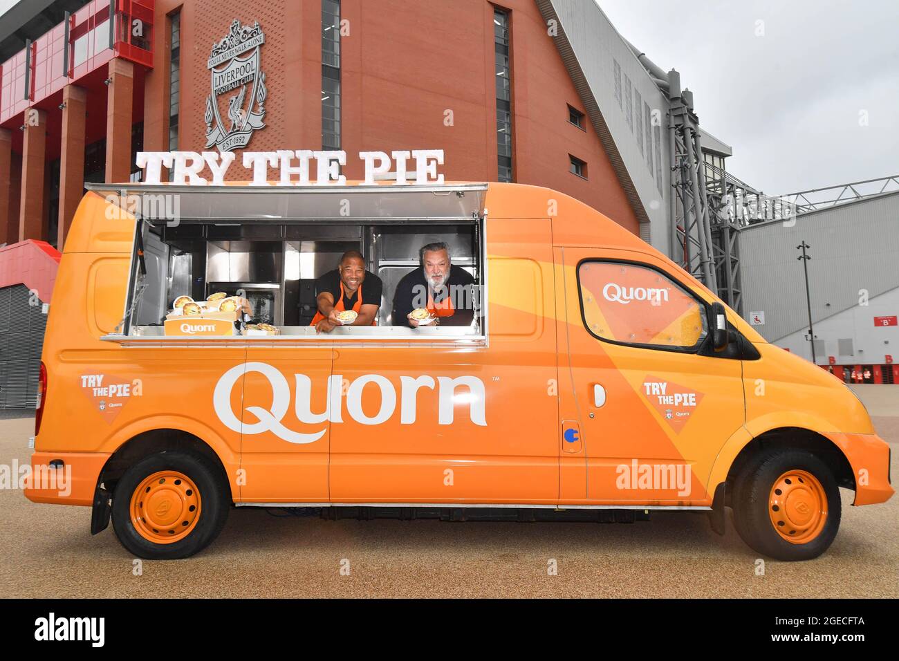 EDITORIAL USE ONLY Former footballers, John Barnes and Neil Ruddock hand out Quorn Meat-Free Steak Match Day Pies, to Liverpool fans at Anfield stadium, ahead of Saturday's match against Burnley. Issue date: Thursday August 19, 2021. Stock Photo