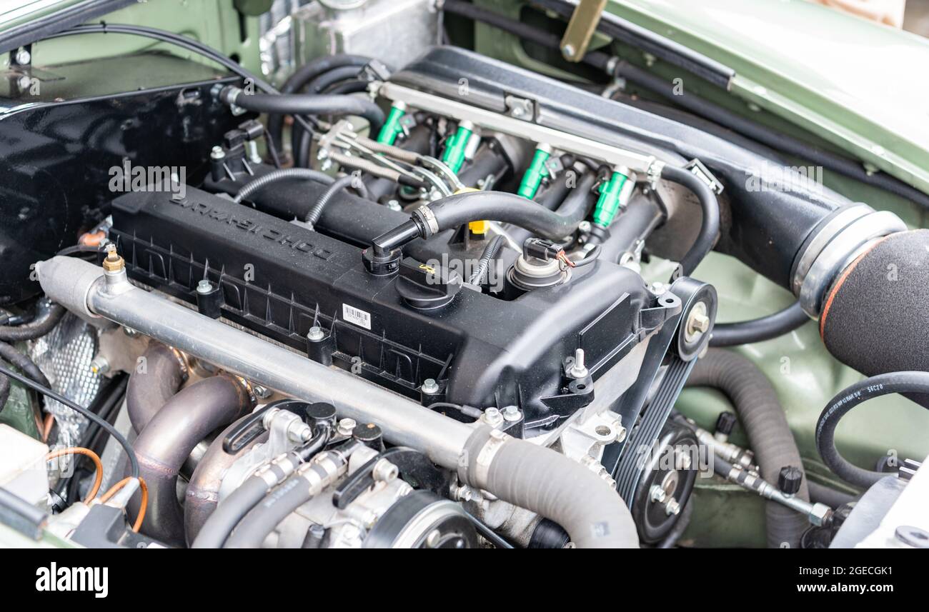 Modern fuel injected engine showing manifold, injectors and drive belts