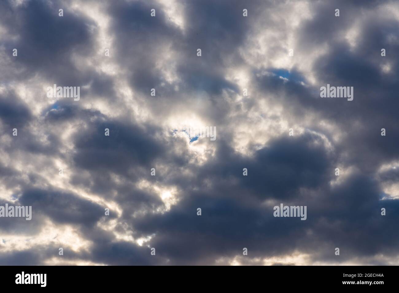 Rays of light shining throug dark clouds.Beautiful dramatic sky with sun rays.dramatic sky sun rays. Stock Photo