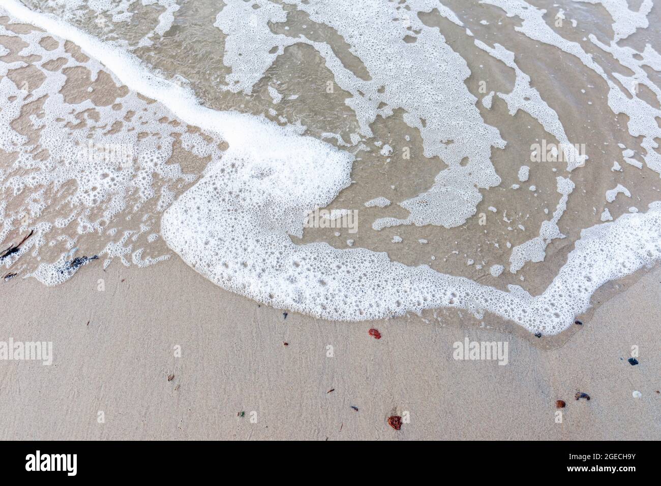 Soft wave of the sea on sandy beach white foam.Top view of a wave ...