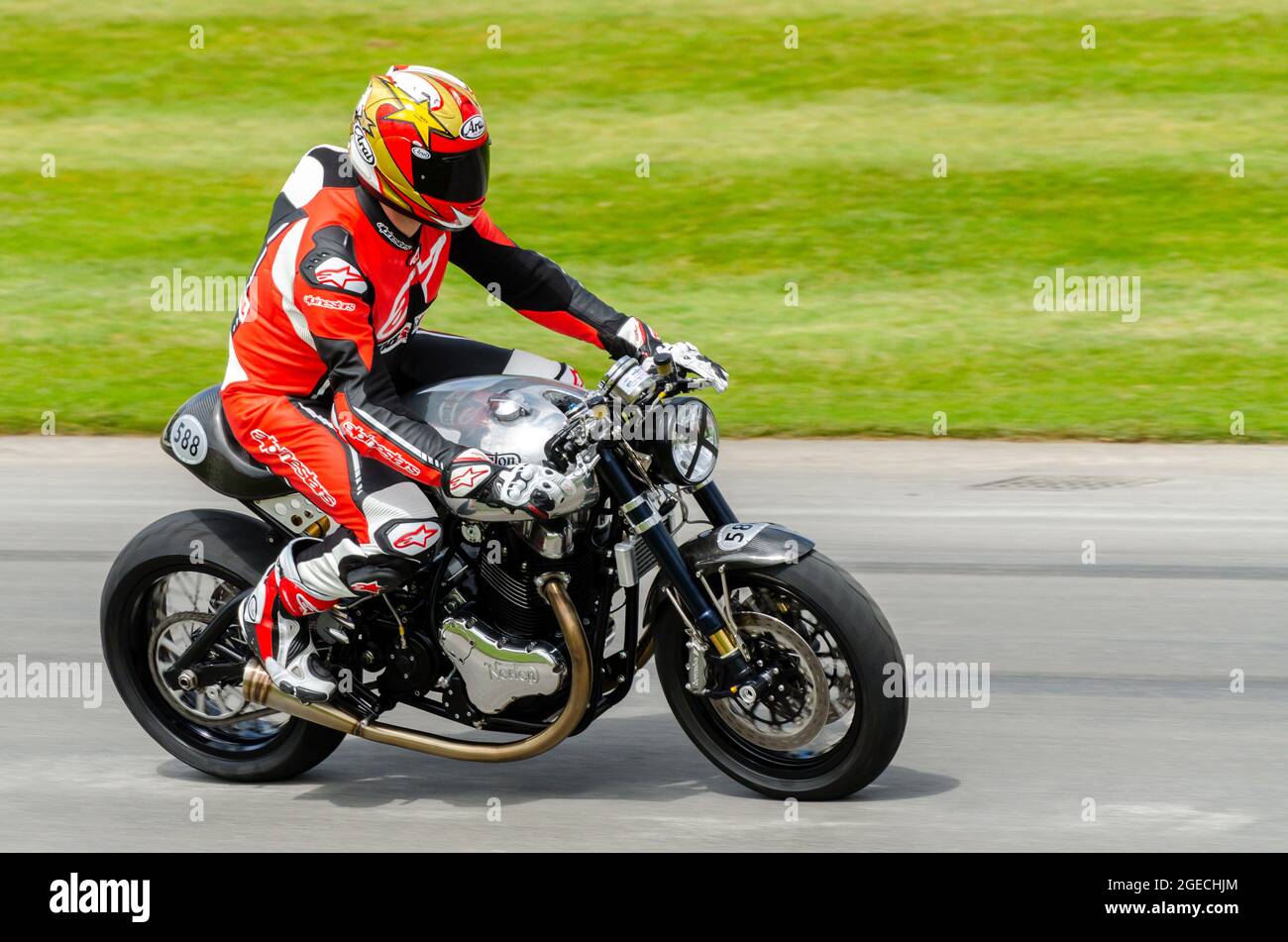 2014 Norton Domiracer motorcycle racing up the hill climb track at the Goodwood Festival of Speed motor racing event 2014. Limited edition bike Stock Photo