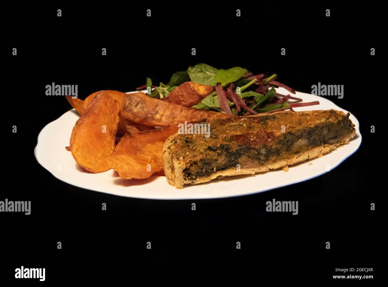 Vegan meal - Vegan Quiche, Sweet Potato Wedges and Beetroot Salad. What Vegans Eat. Stock Photo