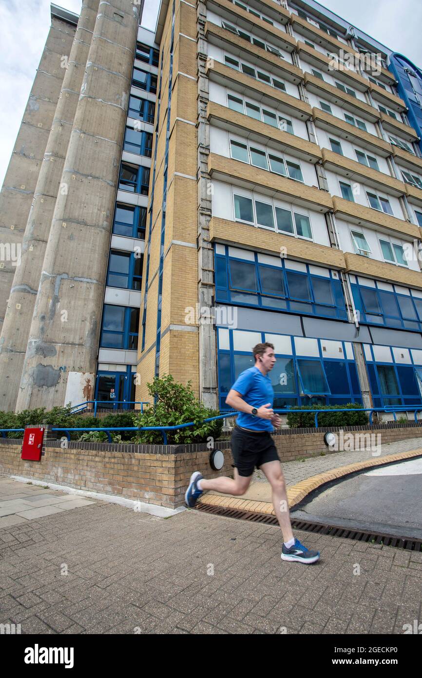 UK ,Kent,Bromley on 14 th of Augusot: Runner is passing  Northpoint building what is being repaired by removing the same deadly material as Grenfell . Stock Photo
