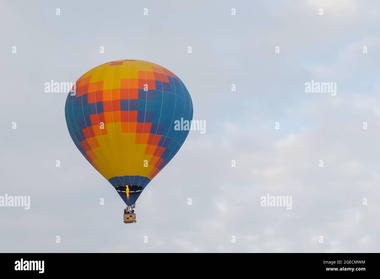 Colorful hot air balloon flying against cloudy winter sky Stock Photo ...