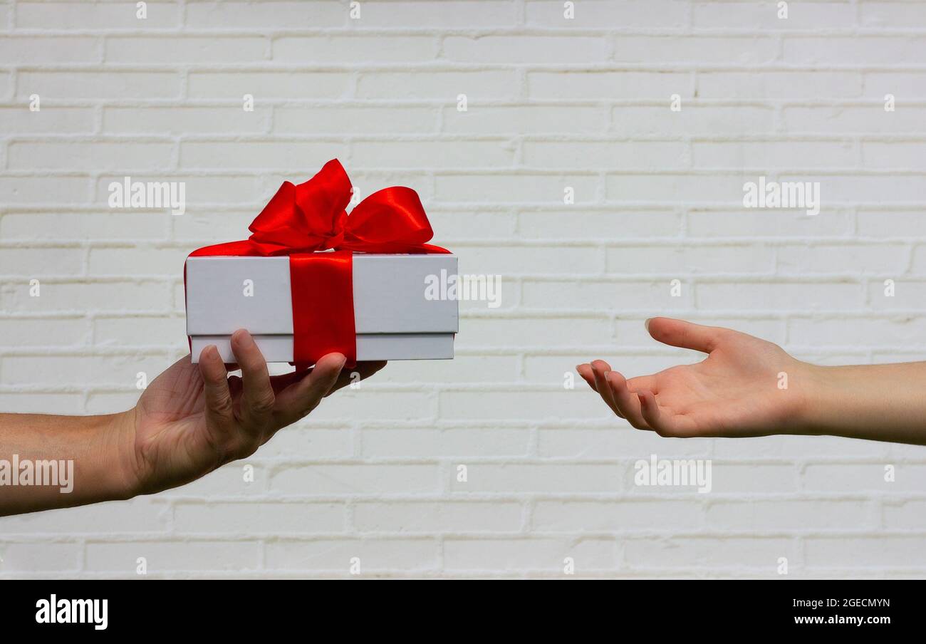 box with a bow in elderly hands Stock Photo