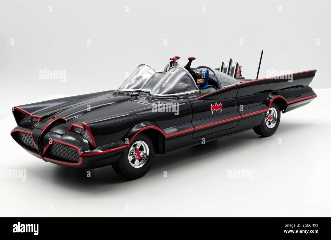 Bologna - Italy - August 19, 2021: Classic Batman action figure inside the Batmobile on white background. Batman from DC comics. Stock Photo