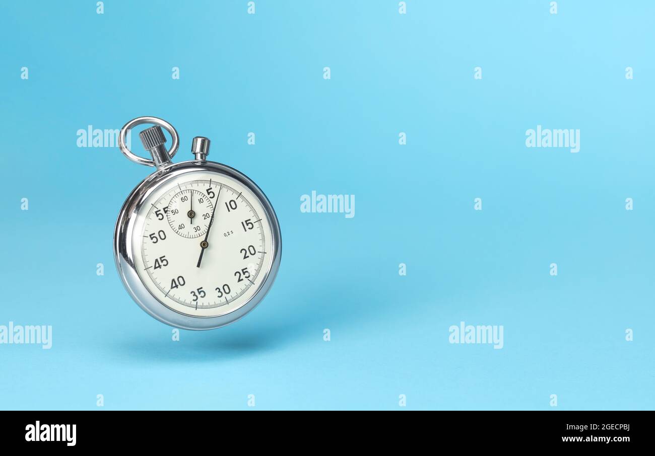 Stopwatch in levitation on blue background. Template Copy space for text. Stock Photo