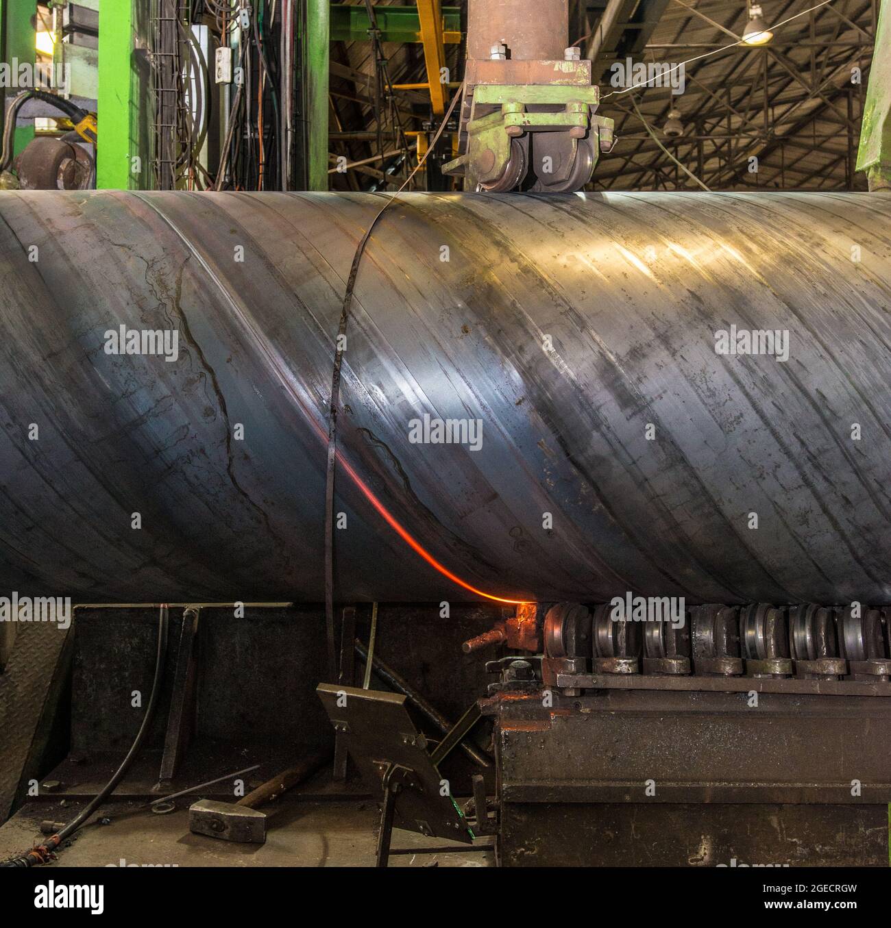 Pipe manufacturing plant. Large diameter Metal pipes factory welding the rolled metal Stock Photo