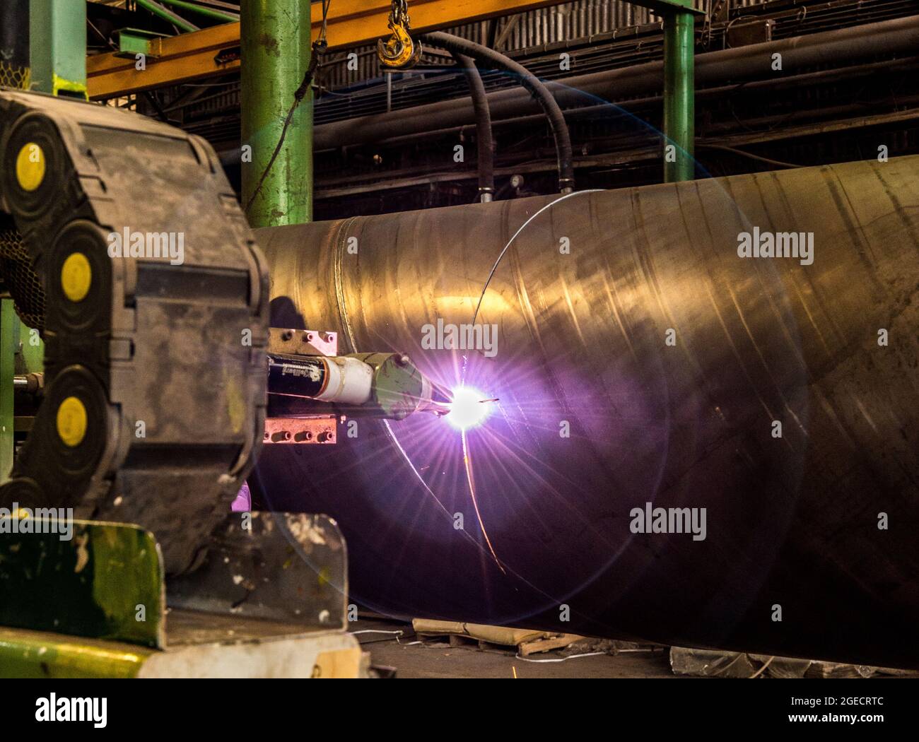 Pipe manufacturing plant. Large diameter Metal pipes factory welding the rolled metal Stock Photo