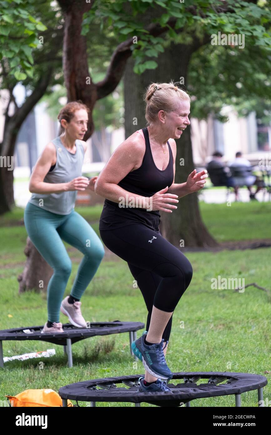 Rebounding Class A fit athletic woman smiles during a rigorous Urban Rebounding class in ...
