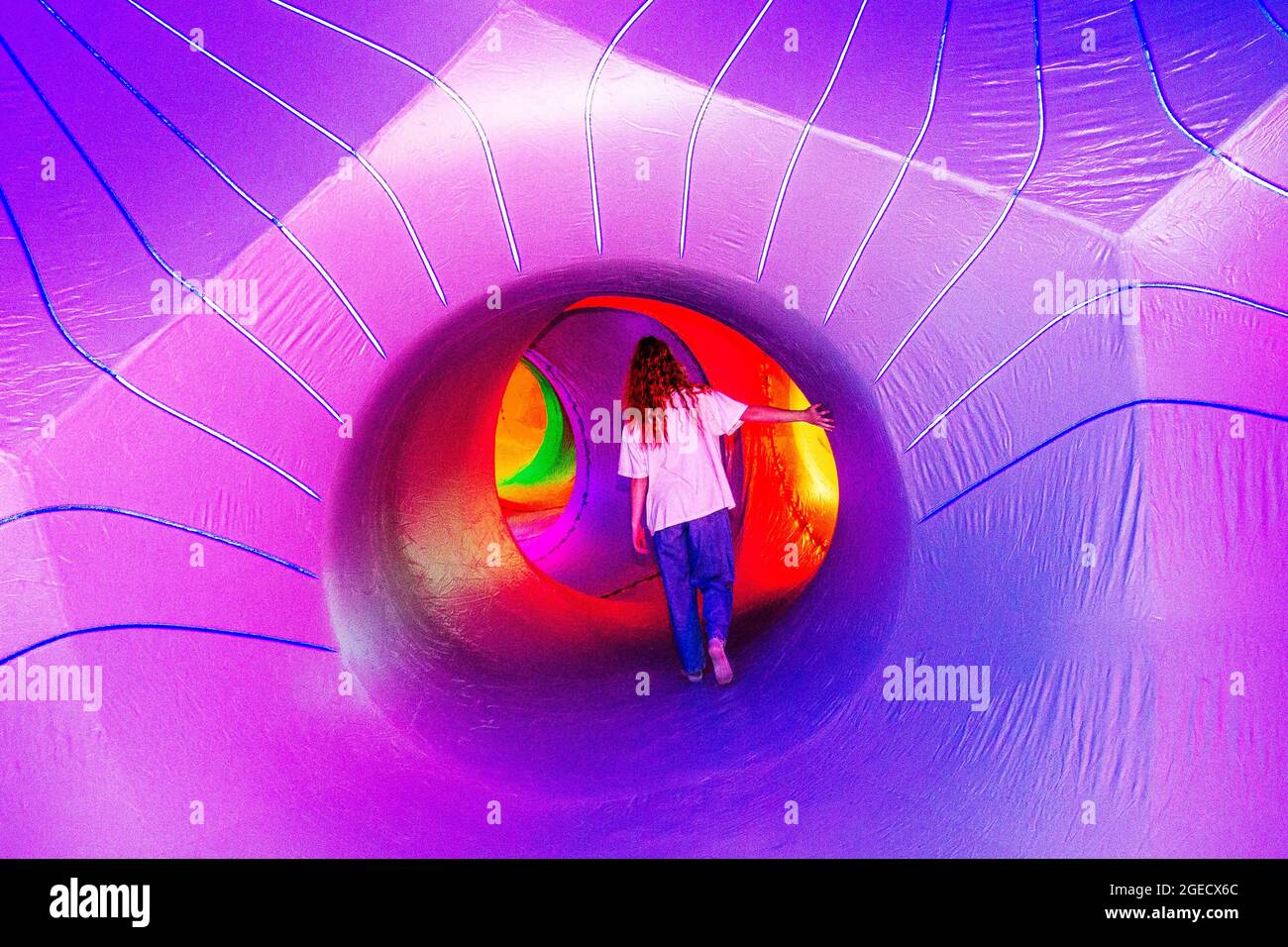 Dodecalis - Architects of Air in Blackburn, Lancashire, UK.  Aug 2021.  Zoe Felix explores the changing patterns of light, shifting as they pass through labyrinthine passages, Dodecalis Luminarium provides moments of pause in meditative stillness and quiet wonder in the furthest corners of the precision-engineered, ‘hide and seek’ illuminated colour tunnels of light architecture. Stock Photo