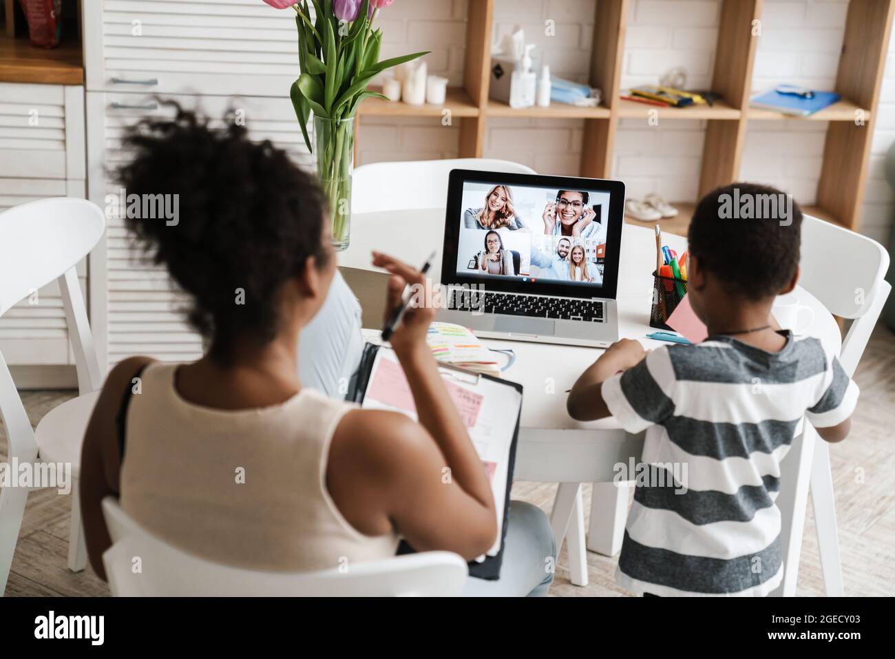 Black mother and son using laptop while working at home Stock Photo