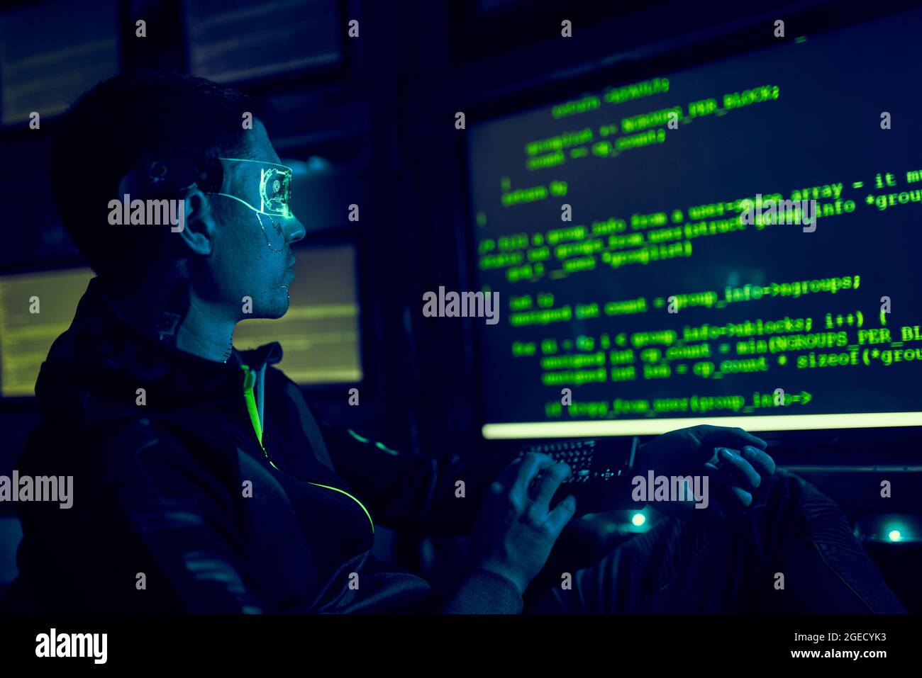 Cyber hacker breaks into databases to obtain information using a computer. Cybercrime and data security concept. Stock Photo