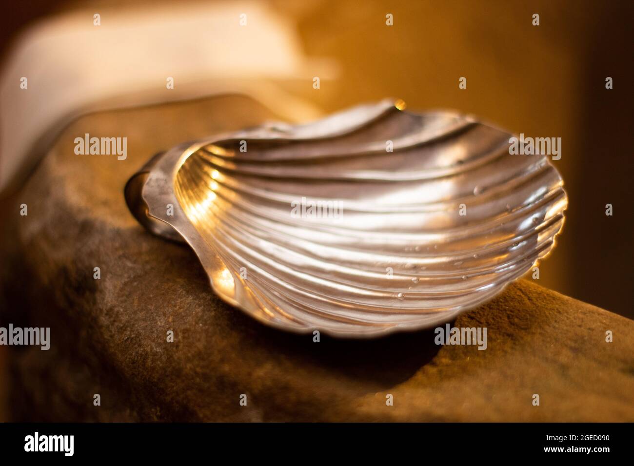 Silver shell used for the baptism ritual Stock Photo Alamy