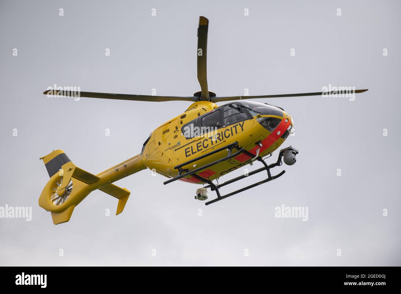 A helicopter run by the UK's National Grid electricity supply making routine inspections over Warwickshire, UK. Stock Photo