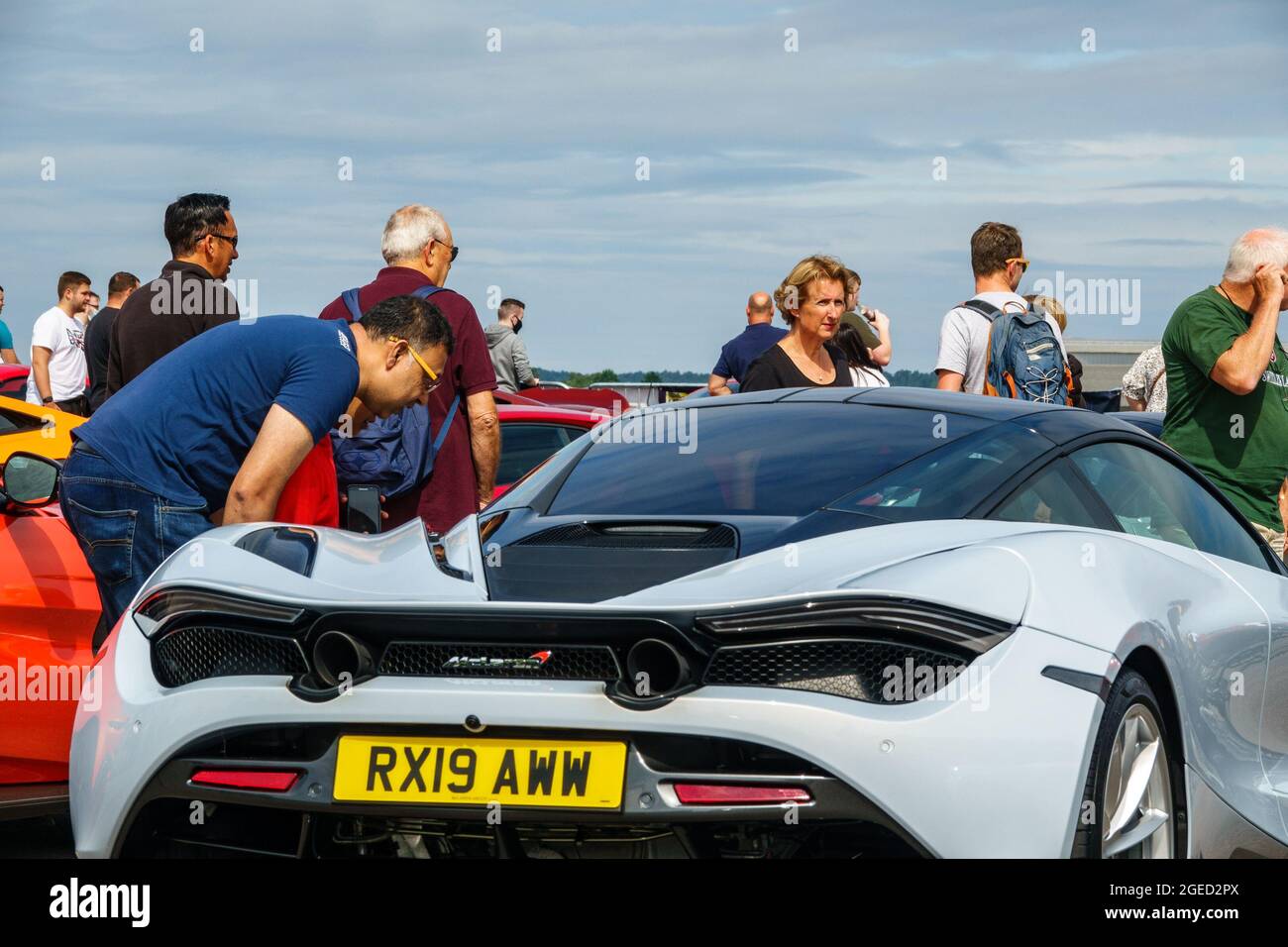 Farnborough, 19th August, 2021. A man looks inside a white McLaren