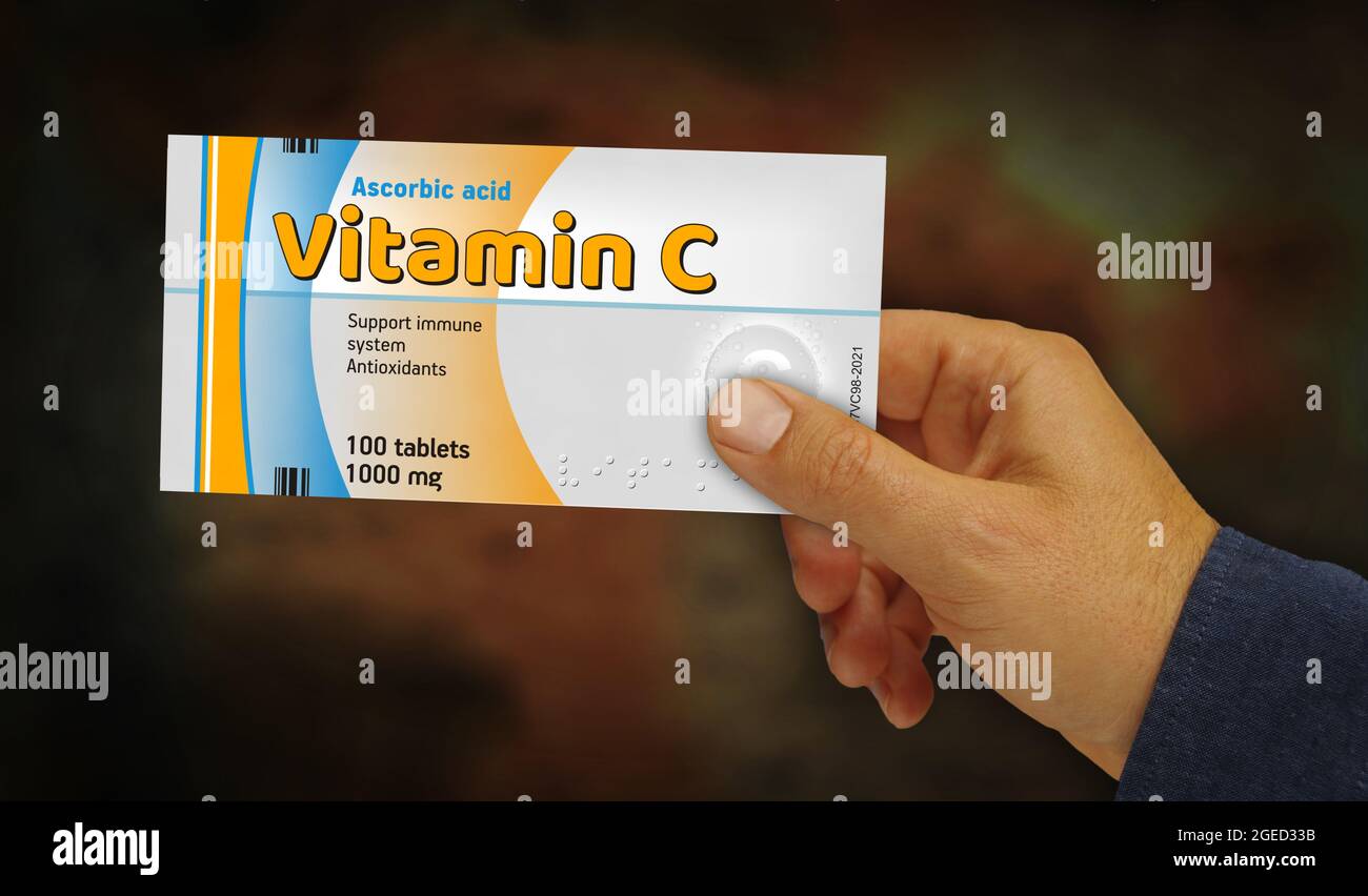 Vitamin C tablets box in hand. Health supplement pills pack factory. Abstract concept 3d rendering illustration. Stock Photo
