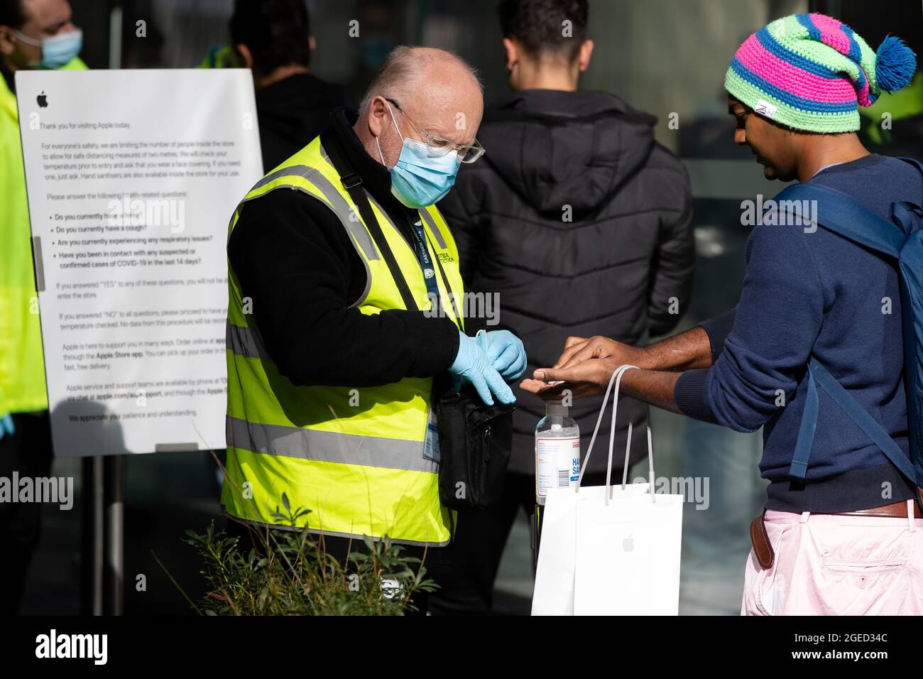 Sydney, Australia, 6 July, 2020. Apple store Sydney security applies hand sanitiser to customer. Sydney continues to ease lockdown restriction as the New South Wales-Victoria border will be closed from 11.59pm Tuesday Night Credit: Pete Dovgan/Speed Media/Alamy Live News Stock Photo