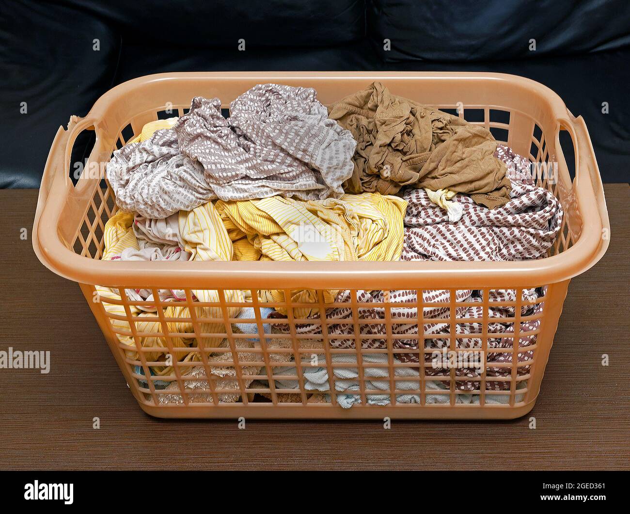 Washed wet clean laundry clothes pile inside plastic container Stock