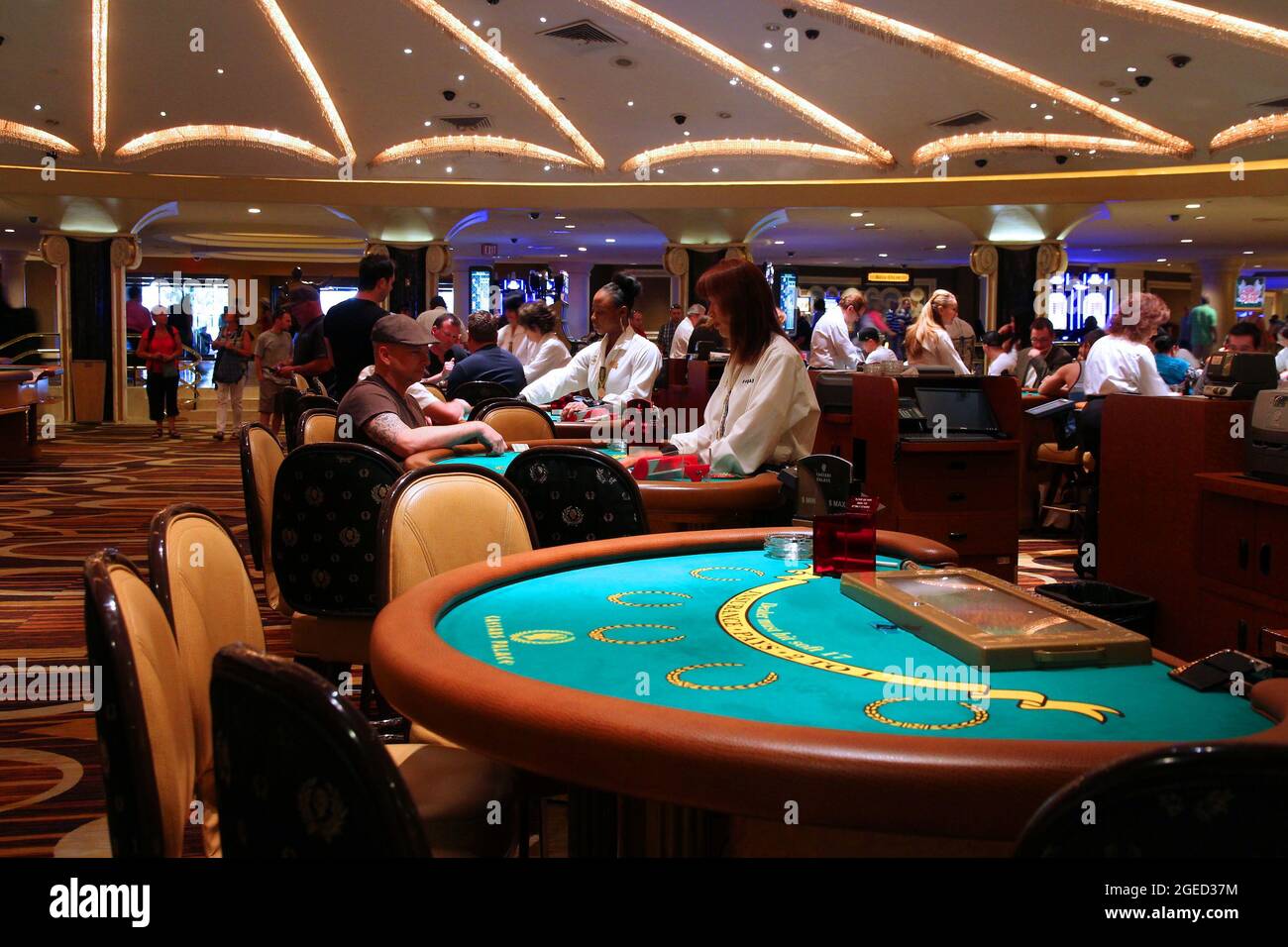 LAS VEGAS, USA - APRIL 14, 2014: People visit Caesar's Palace casino resort in Las Vegas. The famous casino resort has almost 4,000 rooms. Stock Photo