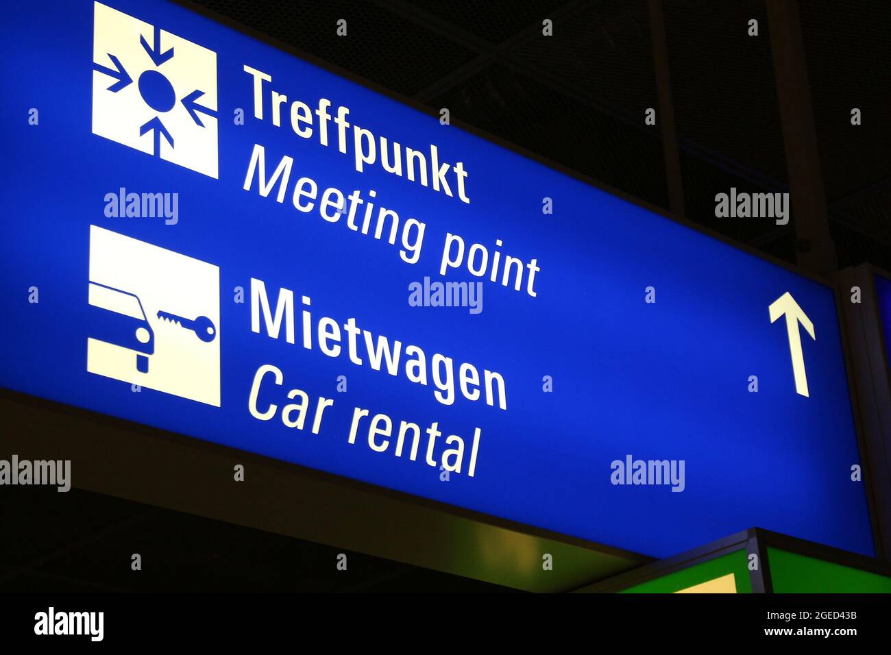 Generic airport signage in Frankfurt Airport. Illuminated meeting point