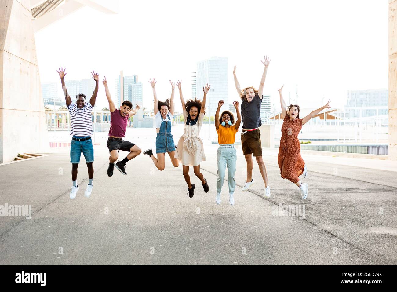 Happy multiracial people jumping together outdoors Stock Photo - Alamy