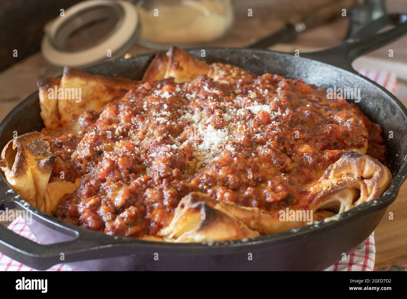 Italian cuisine. filled pancakes with mozzarella cheese, topped with bolognese sauce and parmesan cheese Stock Photo
