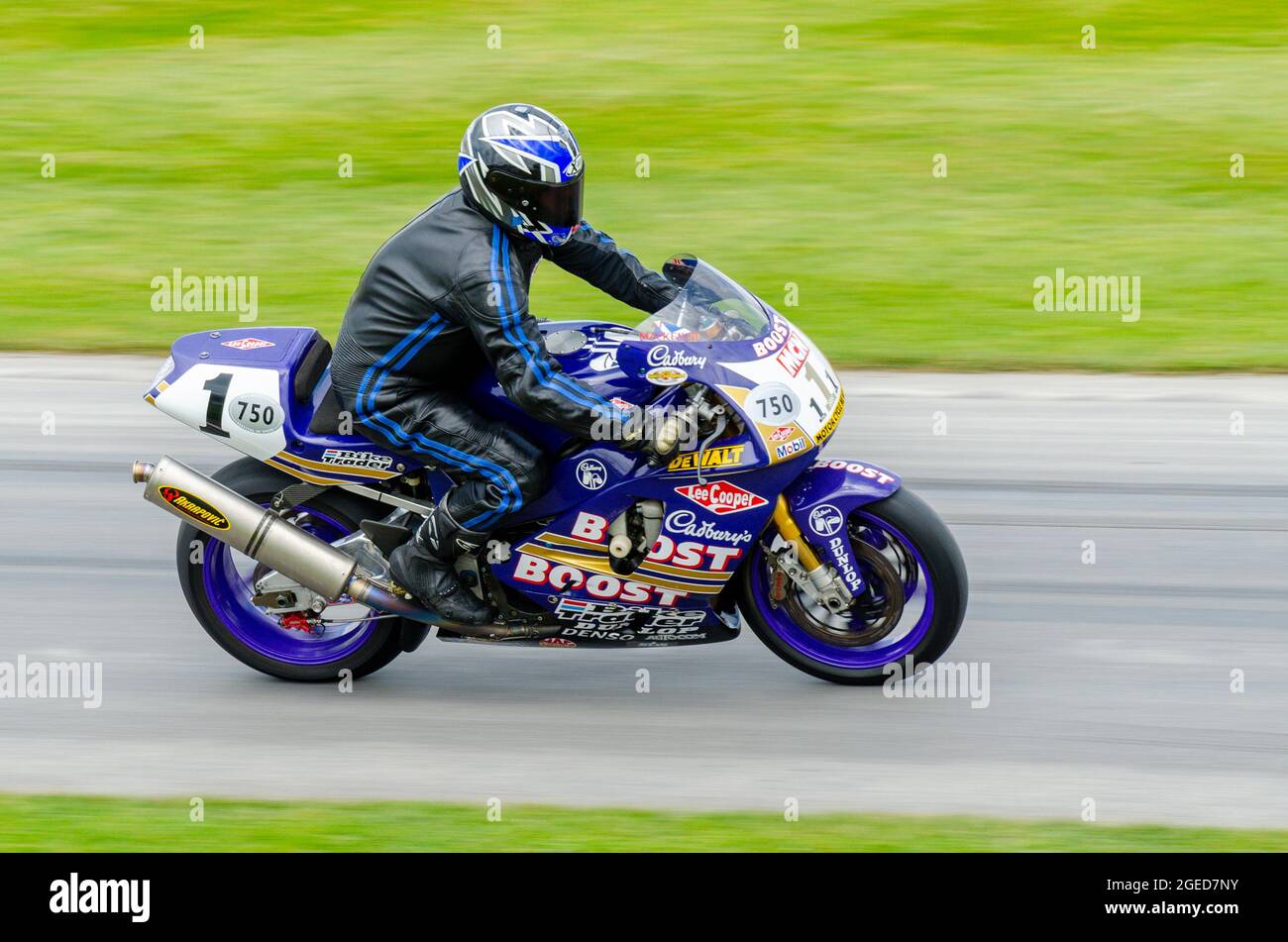 Niall MacKenzie's 1996 Yamaha YZF750 Cadbury Boost Superbike motorcycle racing up the hill climb track at the Goodwood Festival of Speed event 2014 Stock Photo