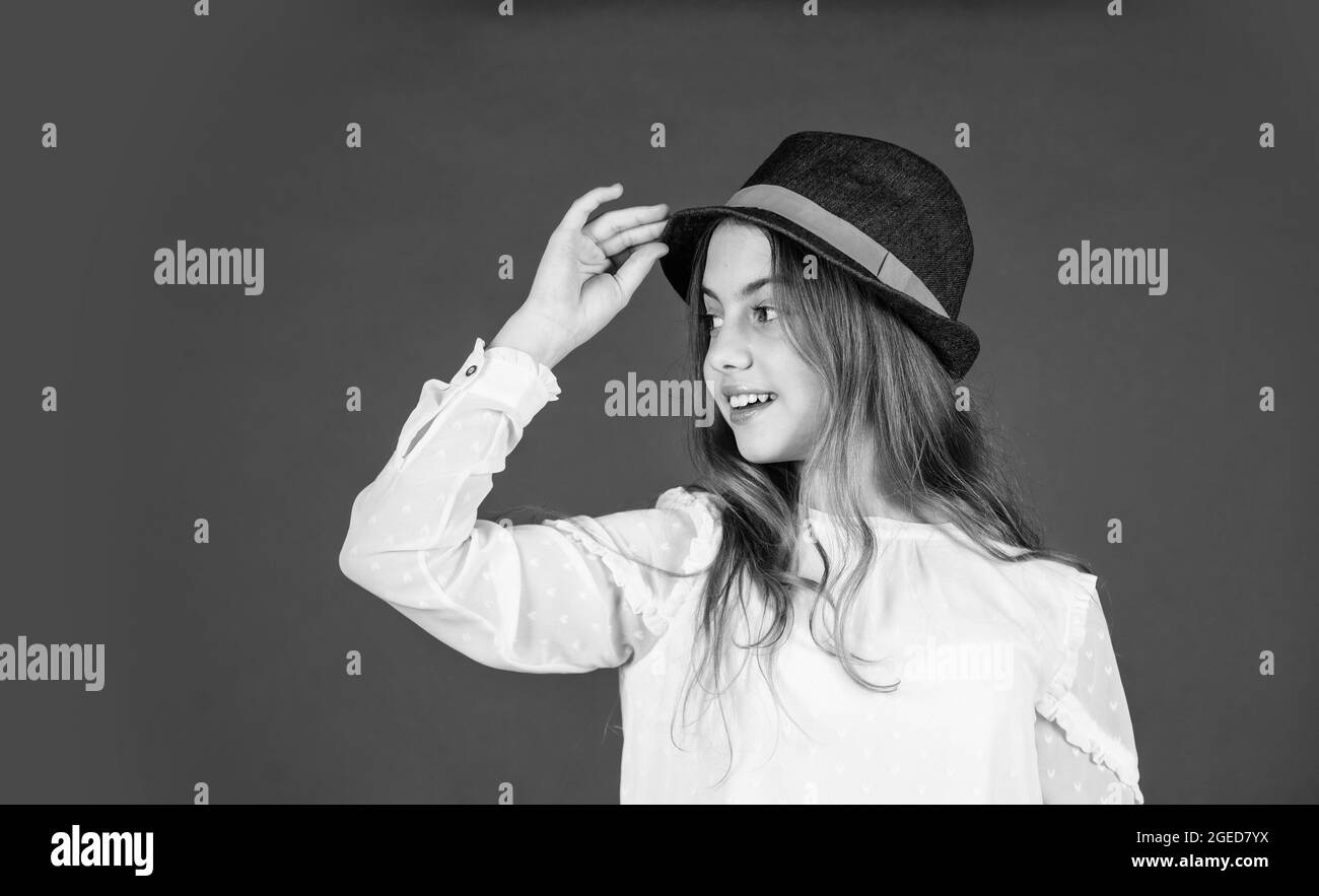 Outfit inspiration. Individual style. Girl wear hat red background