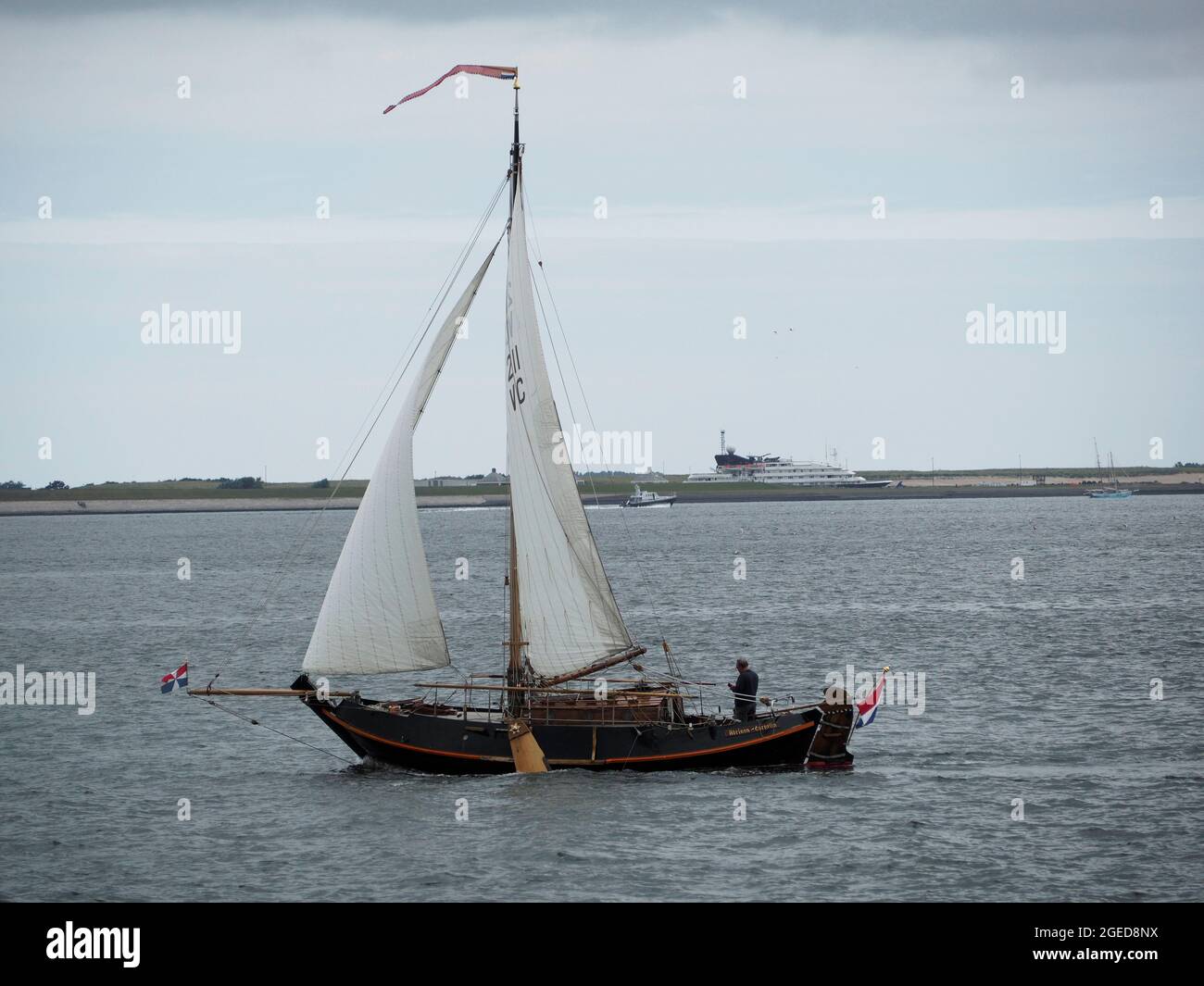 Classic vintage wooden Dutch sailing ship botter type under sail between Den Helder and Texel island, the Netherlands Stock Photo