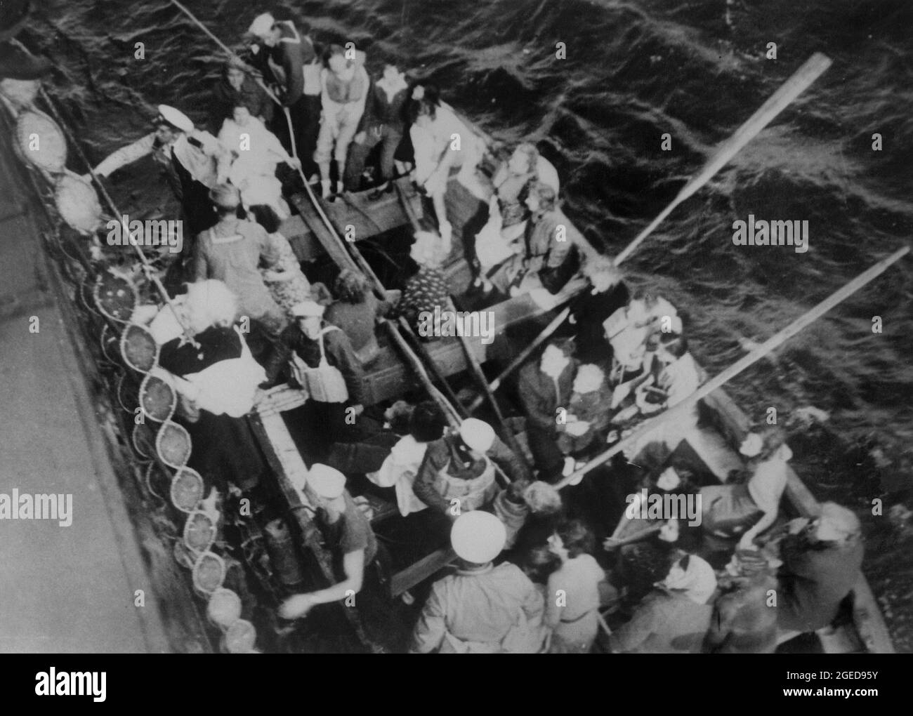 NORTH ATLANTIC OCEAN - 04 September 1939 - An elderly woman is hoisted aboard the American cargo steamship City of Flint after spending the night in a Stock Photo