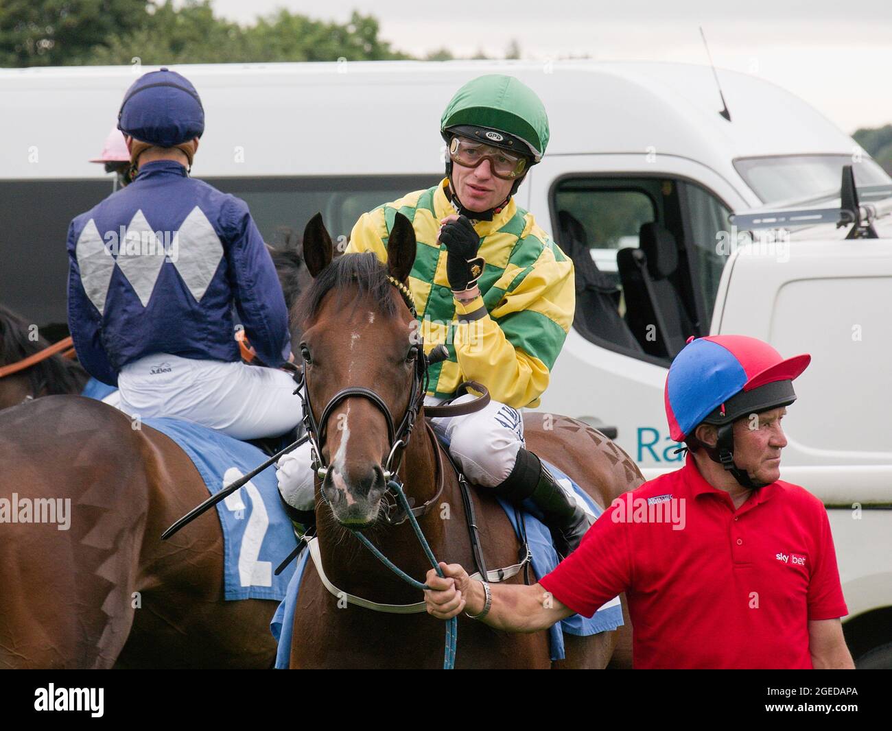 Jockey Cam Hardie on Showtime Mahomes waiting to be led into the starting gates at York Racecourse during the Ebor Racing Festival. Stock Photo