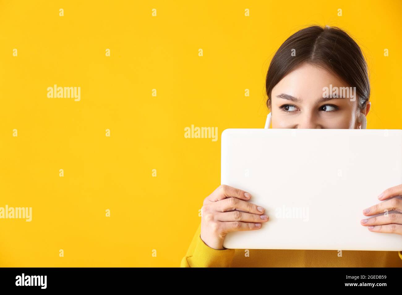Young woman with laptop on color background Stock Photo - Alamy