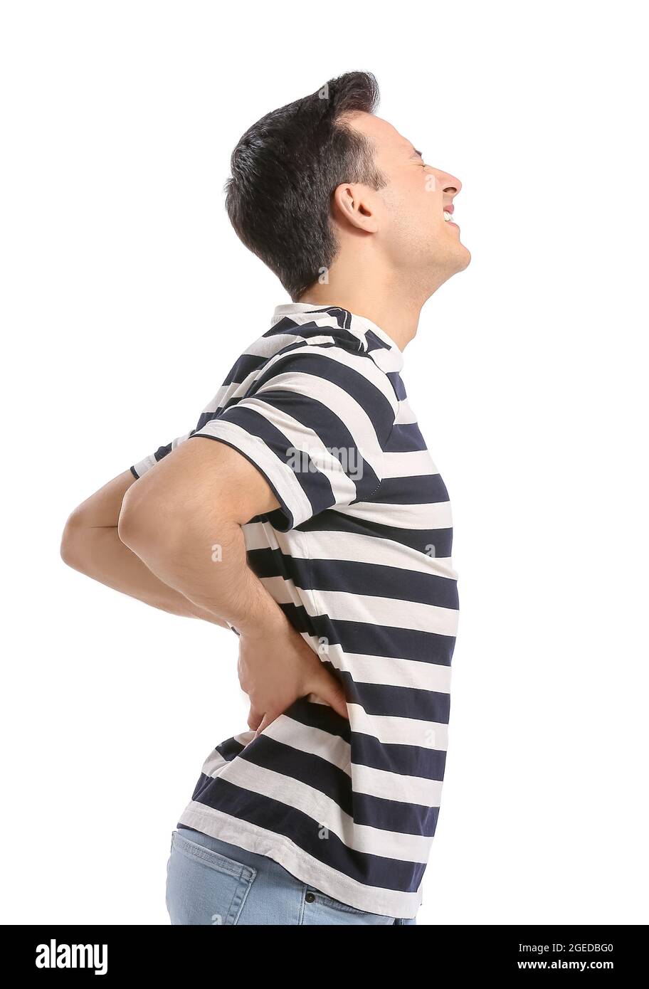 Young man suffering from back pain on white background Stock Photo - Alamy