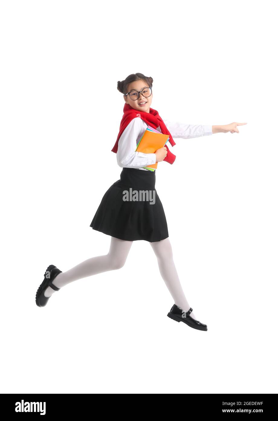 Jumping little schoolgirl with notebooks on white background Stock ...