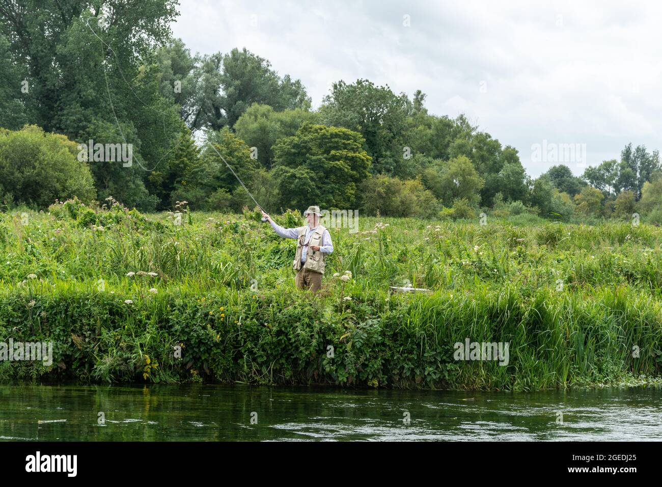 Angler fly fishing on the River Test near Houghton in Hampshire, England, UK Stock Photo