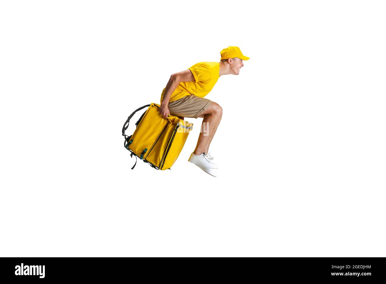 Young delivery man in yellow uniform flying to deliver order isolated ...