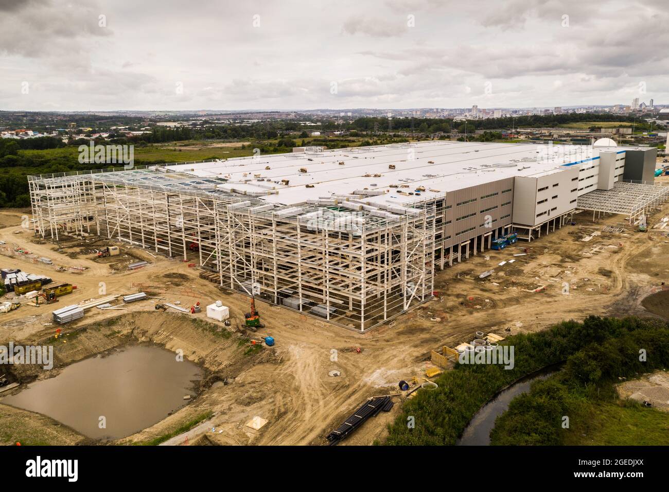 Aerial view of a large distribution centre warehouse on the outskirts of a large city being built and under construction Stock Photo